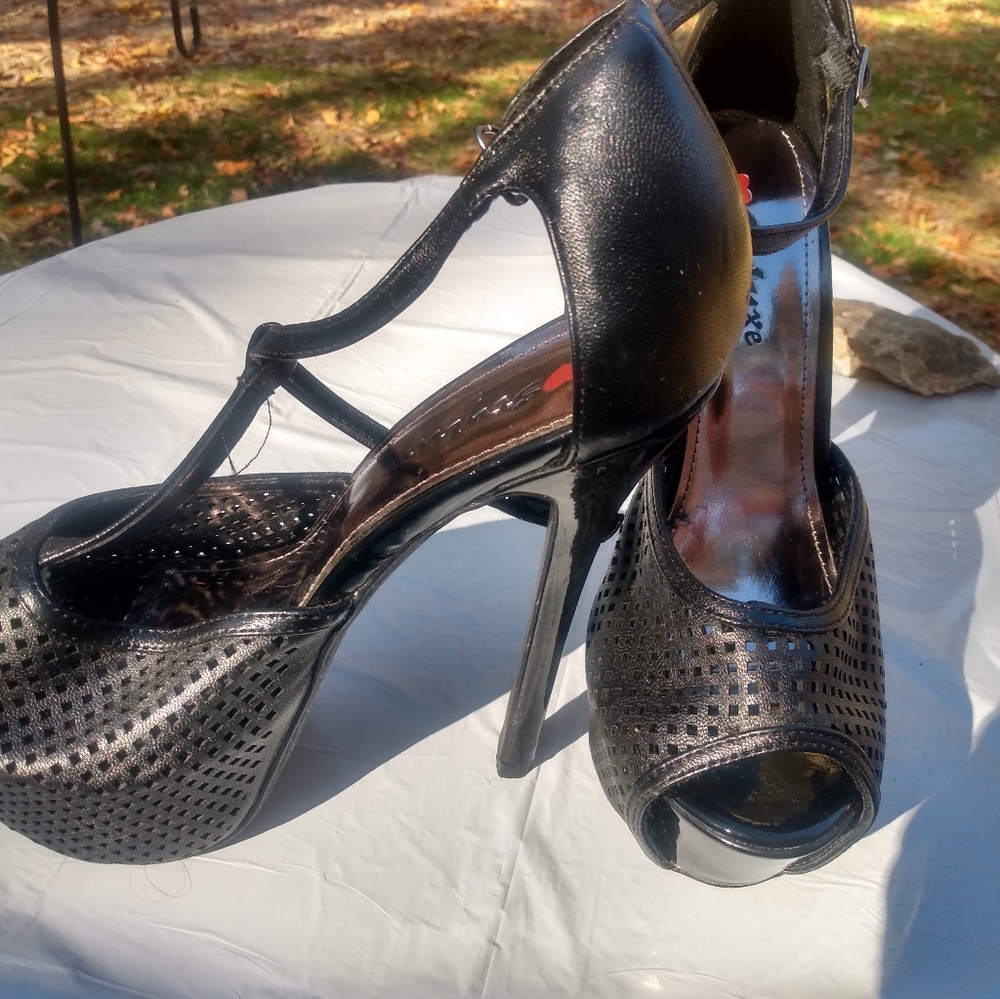 Black strappy sky-high heels.